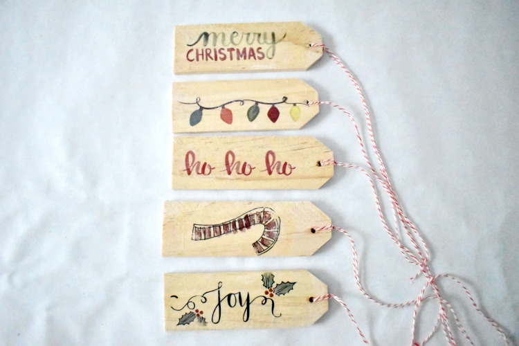 Easily personalize a Christmas gift with a creative DIY gift tag.  There are a lot of gift tag ideas to choose from, but these handmade wooden gift tags are super easy and cute, and can double as ornaments for next Christmas! #gifttags #christmas #thesummeryumbrella